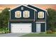Two-story home with dark siding, white garage door, and landscaping at 751 Meadowbrook Ln, Summerville, SC 29486