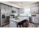 Modern kitchen with gray cabinets, granite island, and stainless steel appliances at 764 Meadowbrook Ln, Summerville, SC 29486