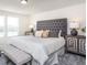 Large bedroom with tufted headboard, bench at the foot of the bed, and nightstands at 764 Meadowbrook Ln, Summerville, SC 29486