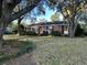 Brick ranch house with mature landscaping and a large front yard at 818 Condon Dr, Charleston, SC 29412