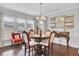 Bright dining room features hardwood floors, a charming table, and large windows at 103 Ivy Terrace Rd, Summerville, SC 29486