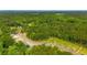 Aerial view of a new community with wooded areas and paved roads at 1064 Crescent Cove Ln, Summerville, SC 29483