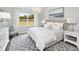 Spacious bedroom with a large bed, white dresser, and grey patterned rug at 147 Royal Cainhoy Way, Huger, SC 29450