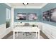 Bright home office features white desk, wood floors, and calming blue walls at 147 Royal Cainhoy Way, Huger, SC 29450