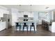 Modern kitchen with white cabinets, granite countertops, and a large island at 147 Royal Cainhoy Way, Huger, SC 29450