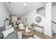 Open concept living room with gray sofa and large windows at 204 Cache Ct, Charleston, SC 29414