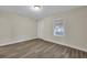 Bright bedroom featuring wood-look floors and a window with blinds at 2265 Bailey Dr, North Charleston, SC 29405