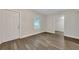 Simple bedroom with wood-look floors and access to another room at 2265 Bailey Dr, North Charleston, SC 29405