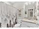 Clean bathroom with a forest-themed shower curtain and granite countertop at 255 S Railroad Avenue, Ridgeville, SC 29472