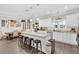 Modern kitchen with white cabinets, granite countertops, and an island with seating at 255 S Railroad Avenue, Ridgeville, SC 29472