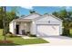 One-story home with white siding, a two-car garage, and a welcoming front porch at 304 Tiliwa Street, Summerville, SC 29486