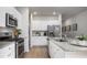 Modern kitchen with white cabinets, granite countertops, and stainless steel appliances at 304 Tiliwa Street, Summerville, SC 29486