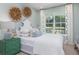 Charming bedroom with white bedding and green accent furniture at 310 Quiet Cove Trl, Summerville, SC 29486