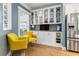 Cozy kitchen nook with yellow armchairs, built-in shelving, and hardwood floors at 311 Bloomington Way, Summerville, SC 29486