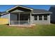 Gray house exterior with screened porch and yard at 318 Abercom Place Dr, Moncks Corner, SC 29461