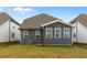 Gray house exterior with sunroom and small yard at 318 Abercom Place Dr, Moncks Corner, SC 29461