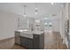 Farmhouse sink and island in an open concept kitchen with hardwood floors at 318 Abercom Place Dr, Moncks Corner, SC 29461