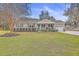 Brick house with green lawn, porch, and attached garage at 3591 Bayou Rd, Johns Island, SC 29455