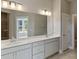 Elegant bathroom with double vanity, large mirror, and herringbone tile floor at 364 Trailmore Ln, Summerville, SC 29486