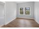 Bright bedroom featuring hardwood floors and two windows at 364 Trailmore Ln, Summerville, SC 29486