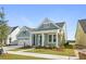 Quaint craftsman style home with light green siding and a welcoming front porch at 364 Trailmore Ln, Summerville, SC 29486
