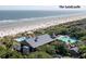 Aerial view of beachfront property with pools and ocean at 4275 Mariners Watch, Kiawah Island, SC 29455