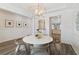 Bright dining room with round table, four chairs, and shiplap walls at 453 Parish Farms Dr, Summerville, SC 29486