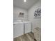 Bright laundry room with washer, dryer, and shelving at 5007 Scow Ct, Summerville, SC 29485