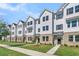 Row of townhouses, featuring white siding and landscaping at 5136 Double Eagle, Summerville, SC 29485