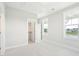 Bright bedroom with carpet flooring, closet, and two windows at 744 Blueway Ave, Summerville, SC 29486
