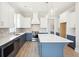 Modern kitchen with white and blue cabinets and large island at 744 Blueway Ave, Summerville, SC 29486