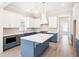 Modern kitchen with white and blue cabinets and large island at 744 Blueway Ave, Summerville, SC 29486