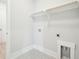 Bright laundry room with patterned flooring and built-in shelving at 744 Blueway Ave, Summerville, SC 29486