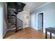 Stunning hallway with spiral staircase and hardwood floors at 75 Lost Village Trl, Edisto Island, SC 29438