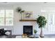 Living room features a fireplace, built-in shelving, and large windows at 763 Maynard Ln, Summerville, SC 29486