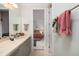 Bathroom with gray cabinets, tile countertop, and access to bedroom at 8 Seagrass Ln, Isle of Palms, SC 29451