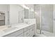Modern bathroom with gray vanity, white countertop, and a walk-in shower at 825 Gentle Breeze Dr, Summerville, SC 29486