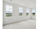Bright bedroom with three large windows and carpet flooring at 825 Gentle Breeze Dr, Summerville, SC 29486