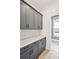 Bright laundry room with gray cabinets and white countertops at 825 Gentle Breeze Dr, Summerville, SC 29486