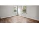 Well-lit bedroom with hardwood floors and two windows at 929 Long Point Rd, Mount Pleasant, SC 29464