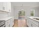 Eat-in kitchen with white cabinets, quartz countertops, and sliding glass door to patio at 929 Long Point Rd, Mount Pleasant, SC 29464