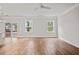 Living room with hardwood floors, two windows, and a ceiling fan at 929 Long Point Rd, Mount Pleasant, SC 29464