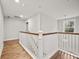 Upstairs hallway with hardwood floors and white railings at 929 Long Point Rd, Mount Pleasant, SC 29464