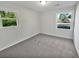 Well-lit bedroom with grey carpet and two windows at 100 Heber Rd, Summerville, SC 29485