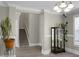 Elegant staircase and display cabinet in a spacious hallway at 102 Teakwood Ct, Summerville, SC 29485