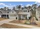 White farmhouse exterior with a metal roof and two-car garage at 1048 Old Field Dr, Summerville, SC 29483