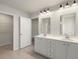 Elegant bathroom with double vanity, white cabinets, and a large mirror at 108 Loon Dr, Summerville, SC 29483