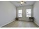 Spacious bedroom with wood-look floors and two windows at 1307 Black Skimmer St, Summerville, SC 29485