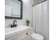 Clean bathroom with white vanity, black fixtures, and shower at 1328 Cottonwood St, Charleston, SC 29403