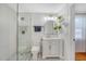 Clean bathroom with glass shower, white vanity, and geometric tile floor at 1328 Cottonwood St, Charleston, SC 29403